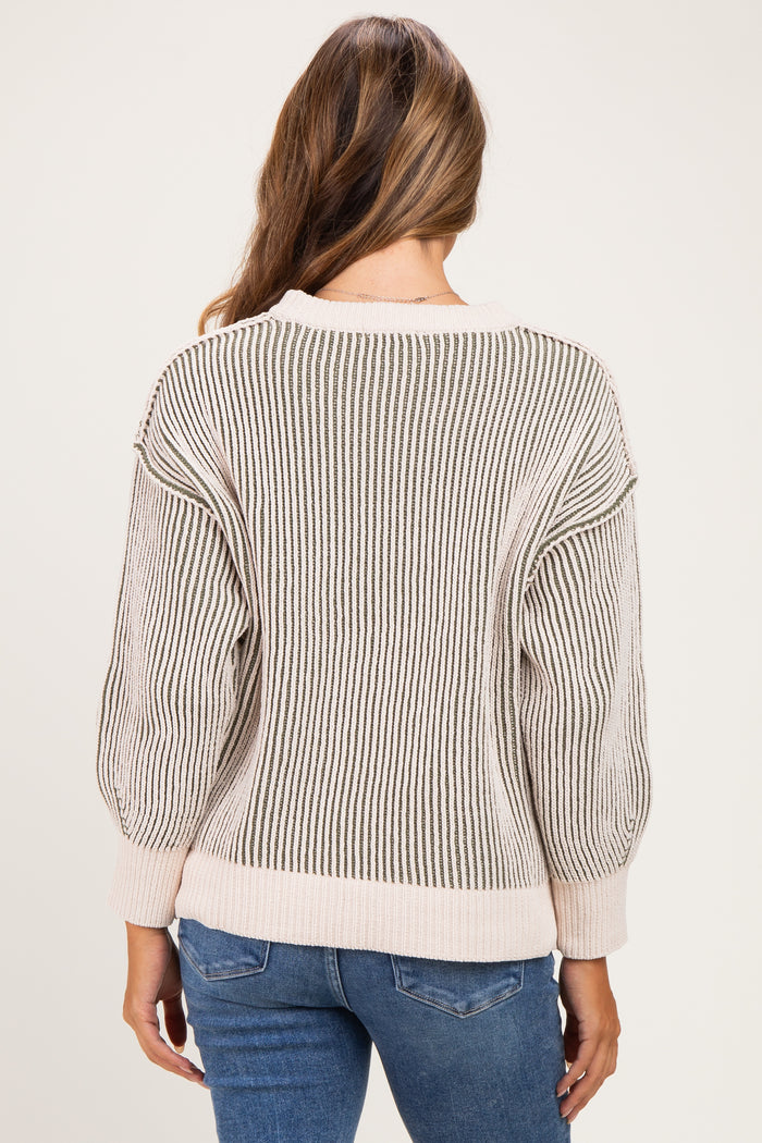 woman wearing a striped maternity sweater with oversized sleeves, shown from the back
