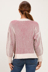 woman wearing a striped reddish beige sweater with balloon sleeves and back view, paired with blue jeans