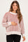woman wearing a striped red and cream maternity sweater and holding her baby bump