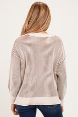 woman wearing a cream and brown striped maternity sweater, showing the back view with a relaxed fit