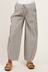 woman wearing maternity striped wide-leg pants with an elastic waistband and drawstring detail