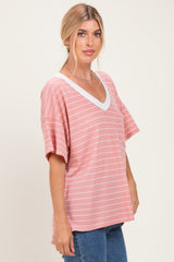 woman wearing a pink and white striped loose-fit v-neck t-shirt with short sleeves
