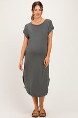 woman wearing a gray short sleeve maternity dress with a relaxed fit and side slits, showing her baby bump