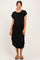 woman wearing a black short sleeve maternity dress with a scoop neckline and side slits, showing a baby bump