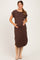 woman wearing a brown short sleeve maternity dress and holding her baby bump