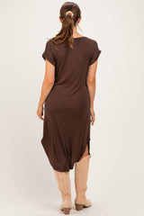 woman wearing a brown maternity dress with short sleeves and side slits, seen from the back