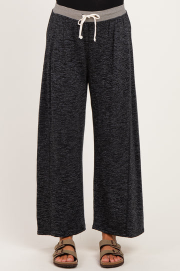 woman wearing comfortable black wide-leg maternity pants with a grey drawstring waistband