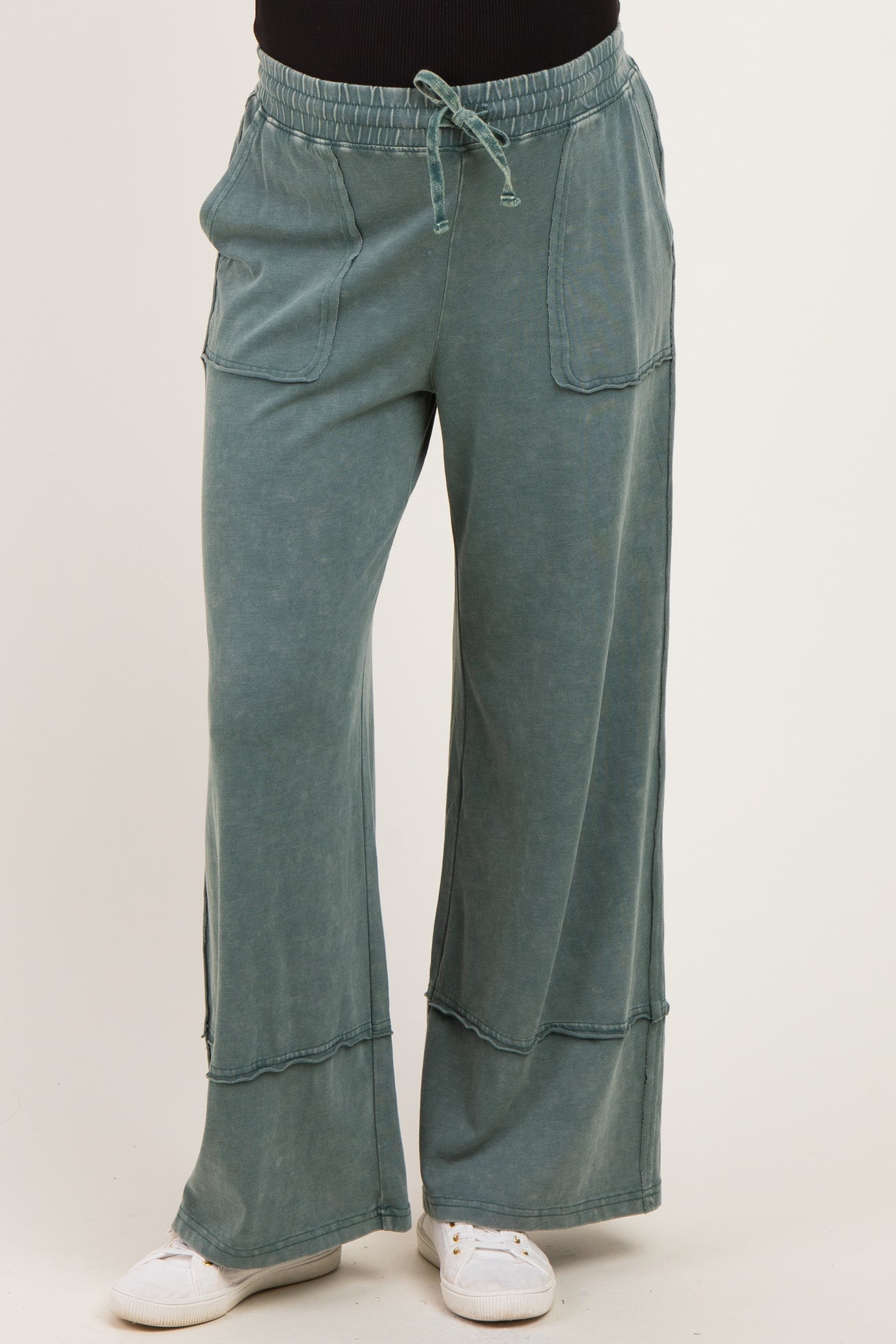 maternity wear wide leg green lounge pants with pockets and drawstring waist, model wearing it