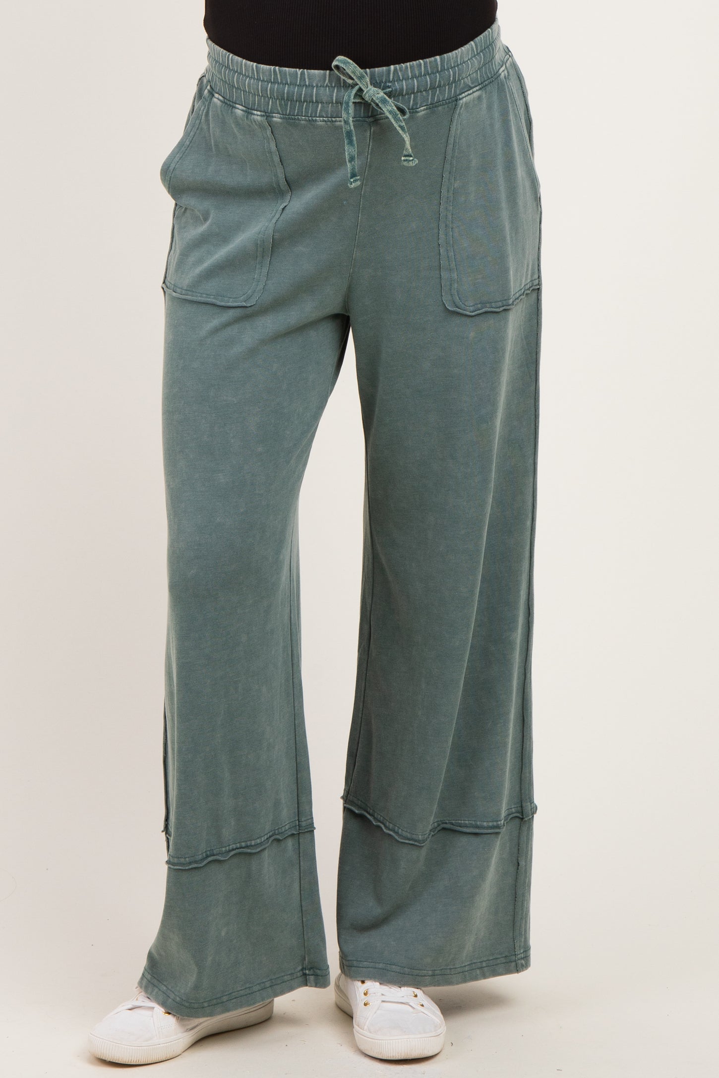 maternity wear wide leg green lounge pants with pockets and drawstring waist, model wearing it