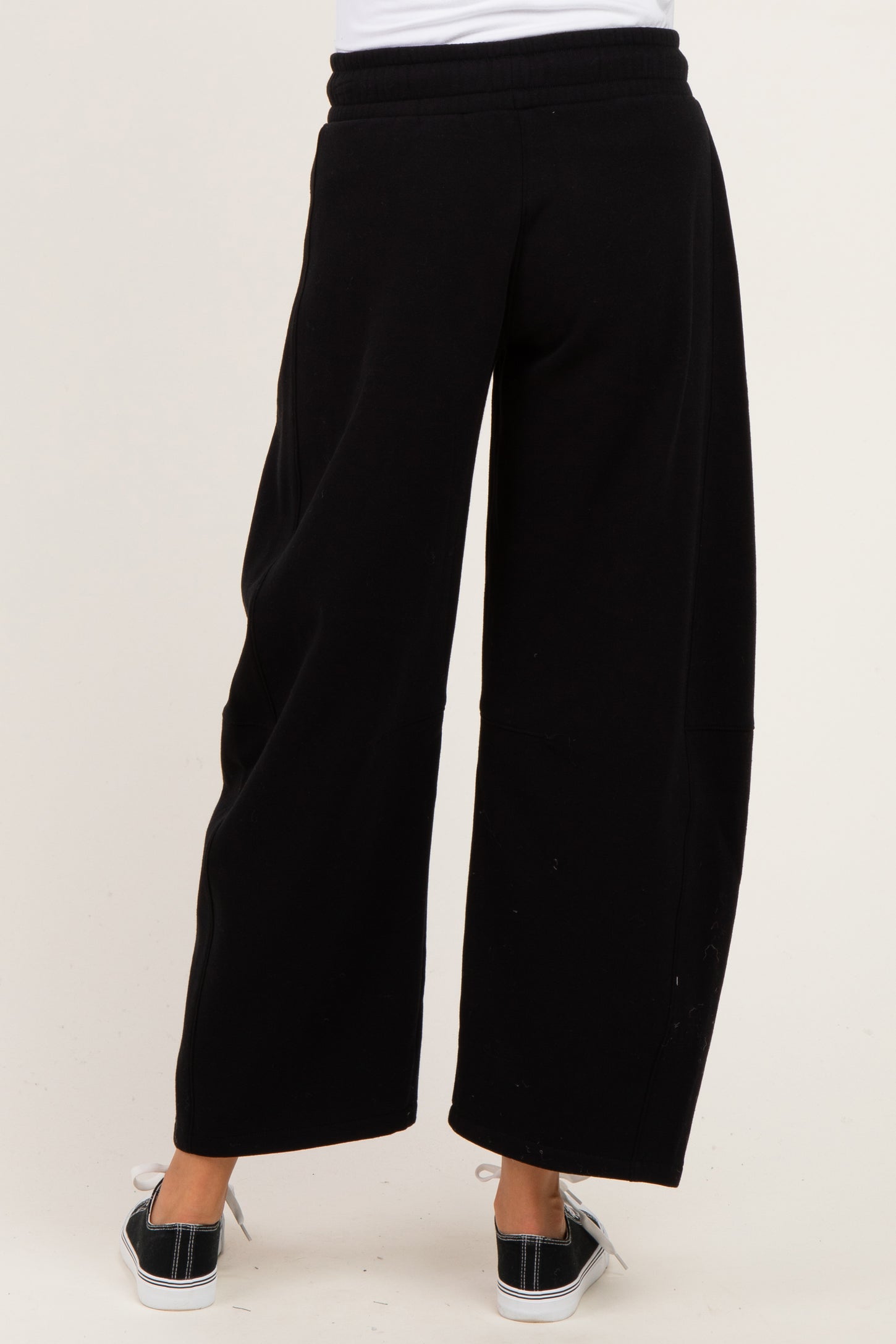 woman wearing black wide-leg maternity pants with a comfortable waistband from the back