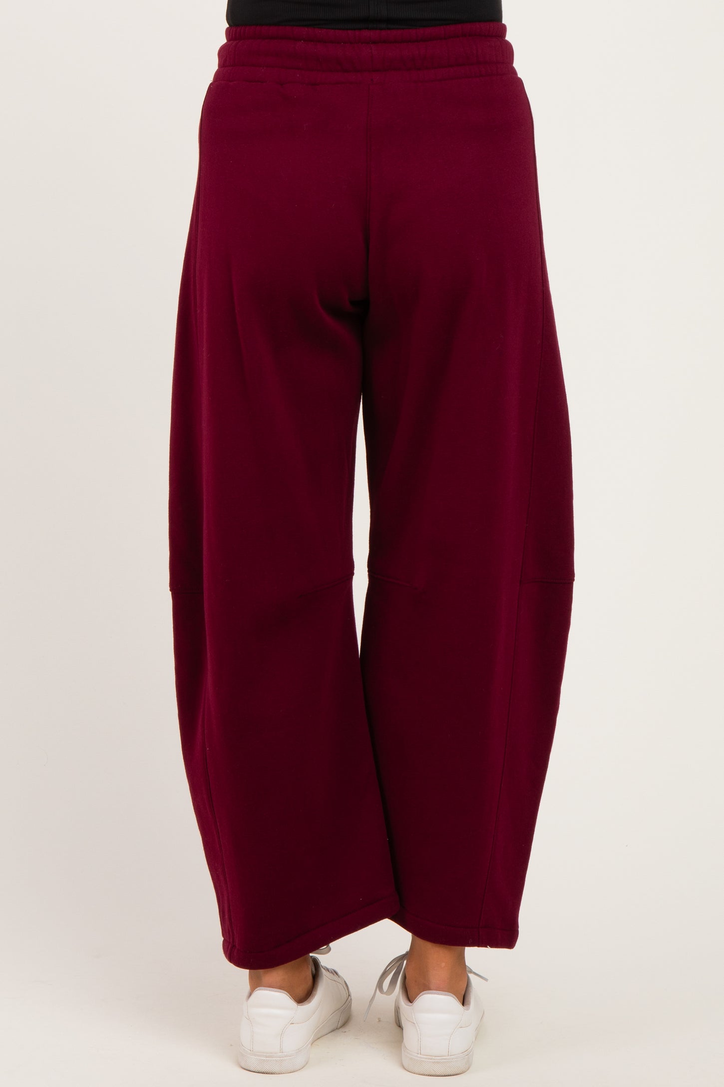 woman wearing maroon maternity wide-leg pants, shown from the back