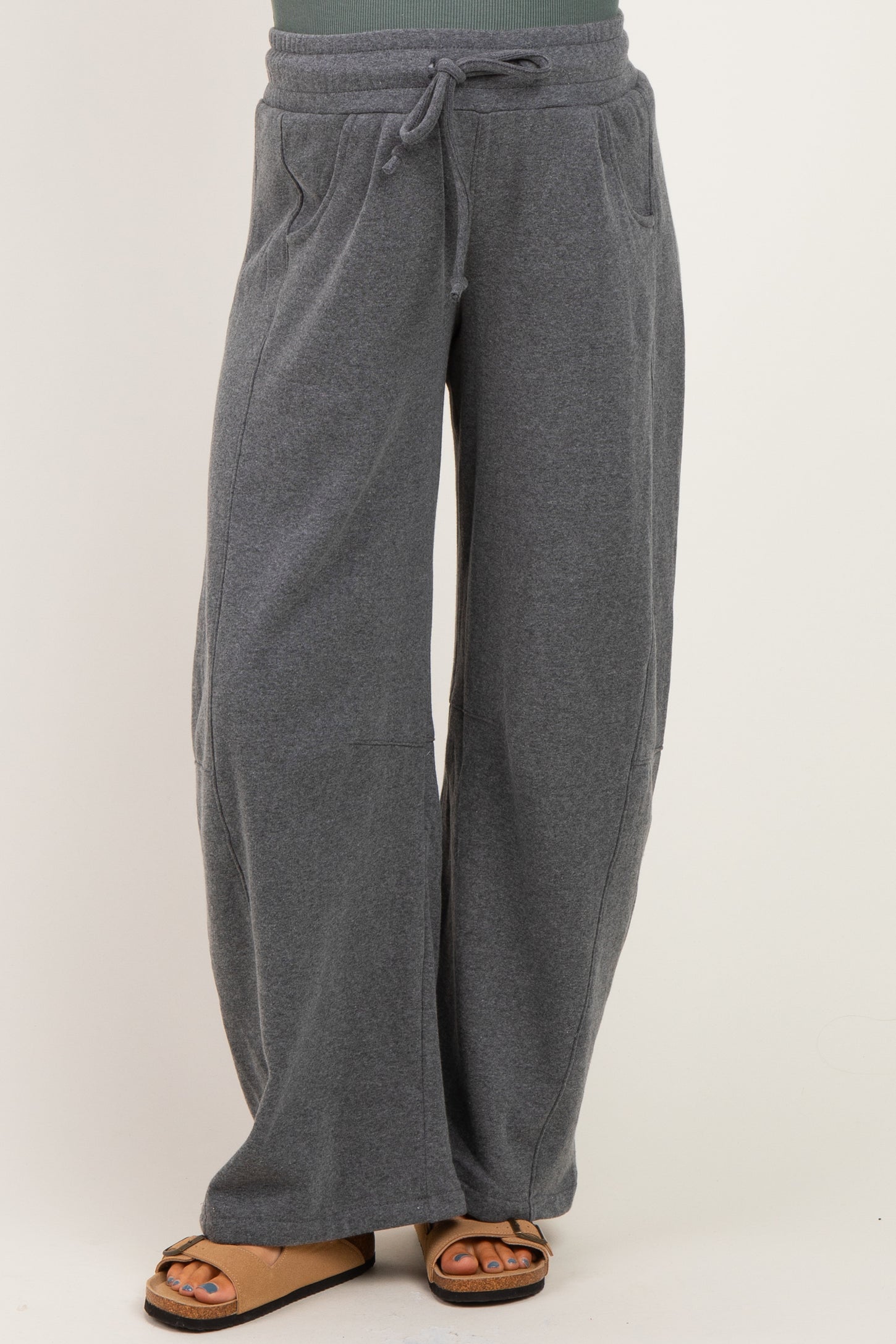 woman wearing gray maternity sweatpants with a drawstring waist and side pockets