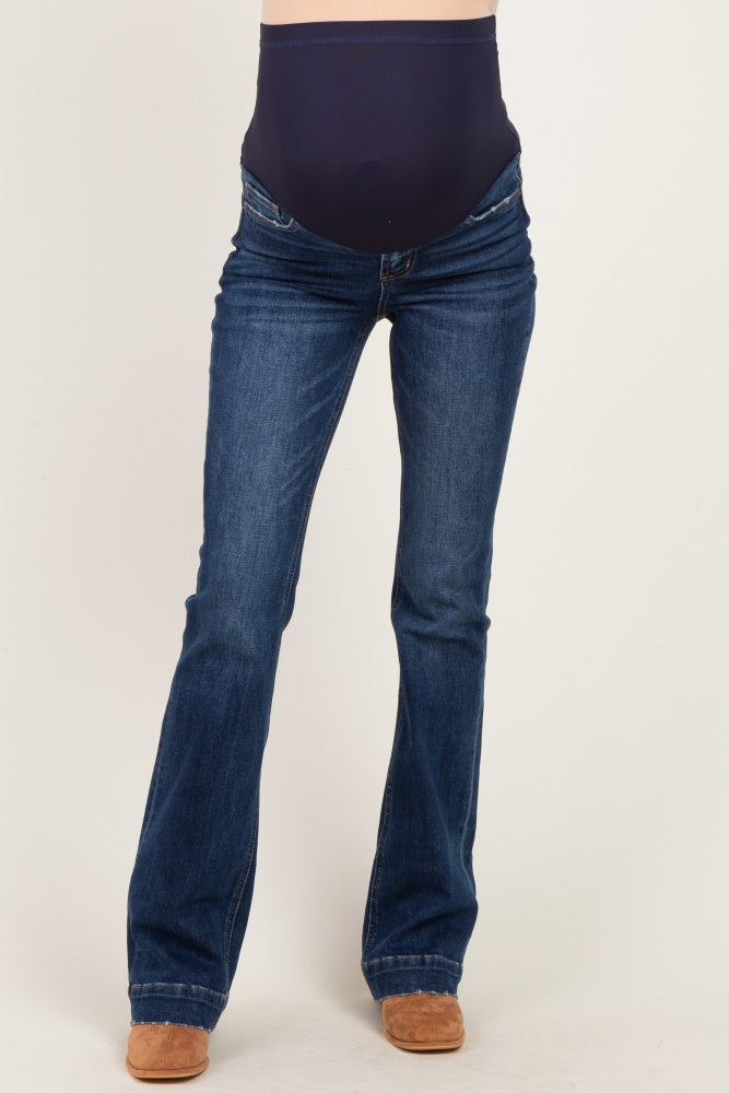 maternity wear dark wash bootcut jeans with a stretchy over-the-belly panel and a model standing upright