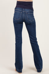 woman wearing dark wash flared maternity jeans with a high waistband from the back