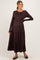 woman wearing a dark brown long sleeve maternity dress with tiered skirt and visible baby bump