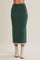 woman wearing a dark green mid-length knitted skirt with a fitted silhouette and side detailing