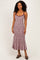 woman wearing a maroon and white striped midi dress with spaghetti straps and a fitted silhouette
