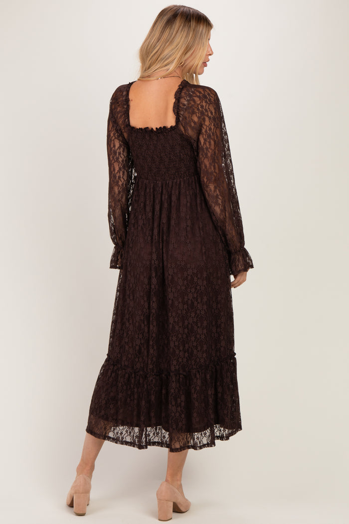 woman wearing a brown lace maxi dress with long sleeves and a ruffled hem, featuring a smocked back detail
