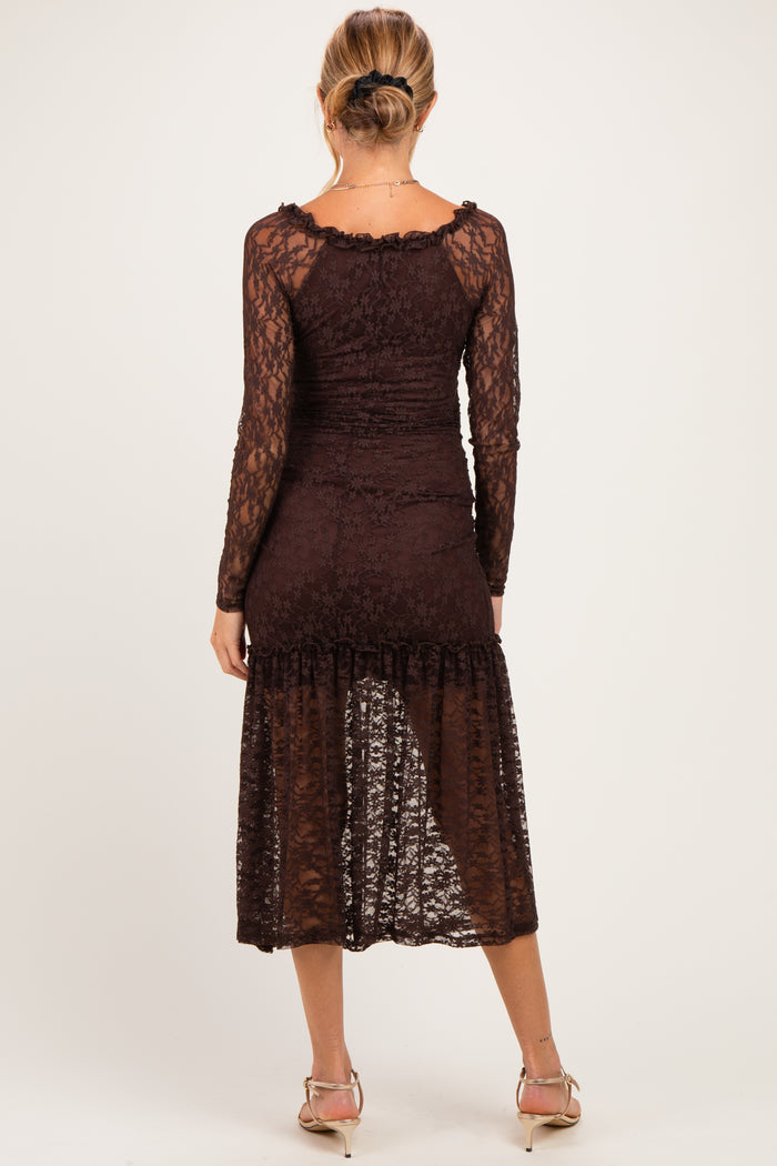 woman wearing a dark burgundy lace maternity dress with long sleeves and a mid-length skirt, showing her back