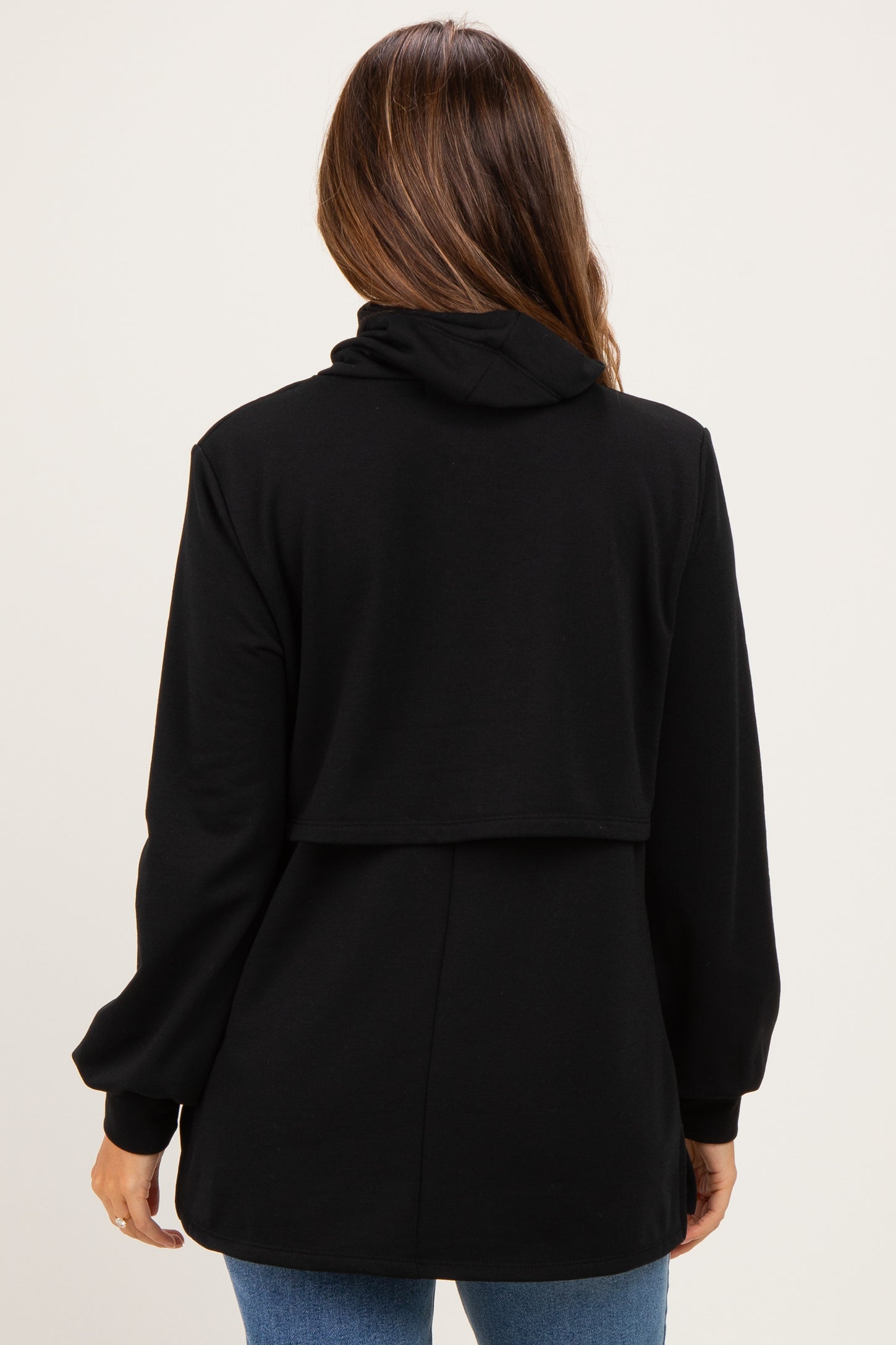 woman wearing a black long sleeve maternity hoodie with a relaxed fit and back panel detail