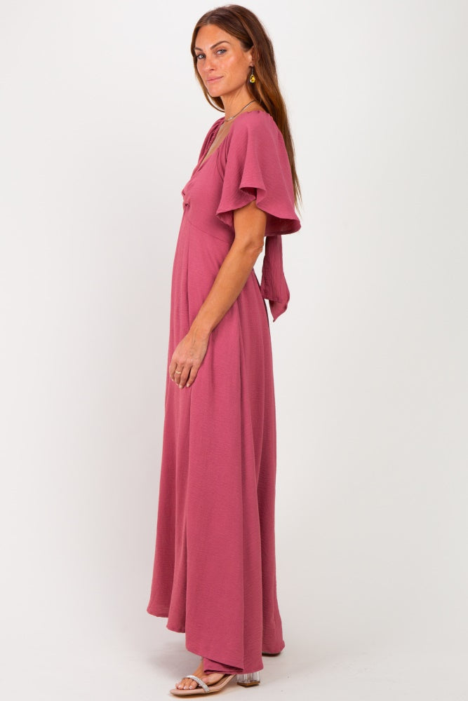 woman wearing a dusty rose maxi dress with flutter sleeves and a flowy silhouette