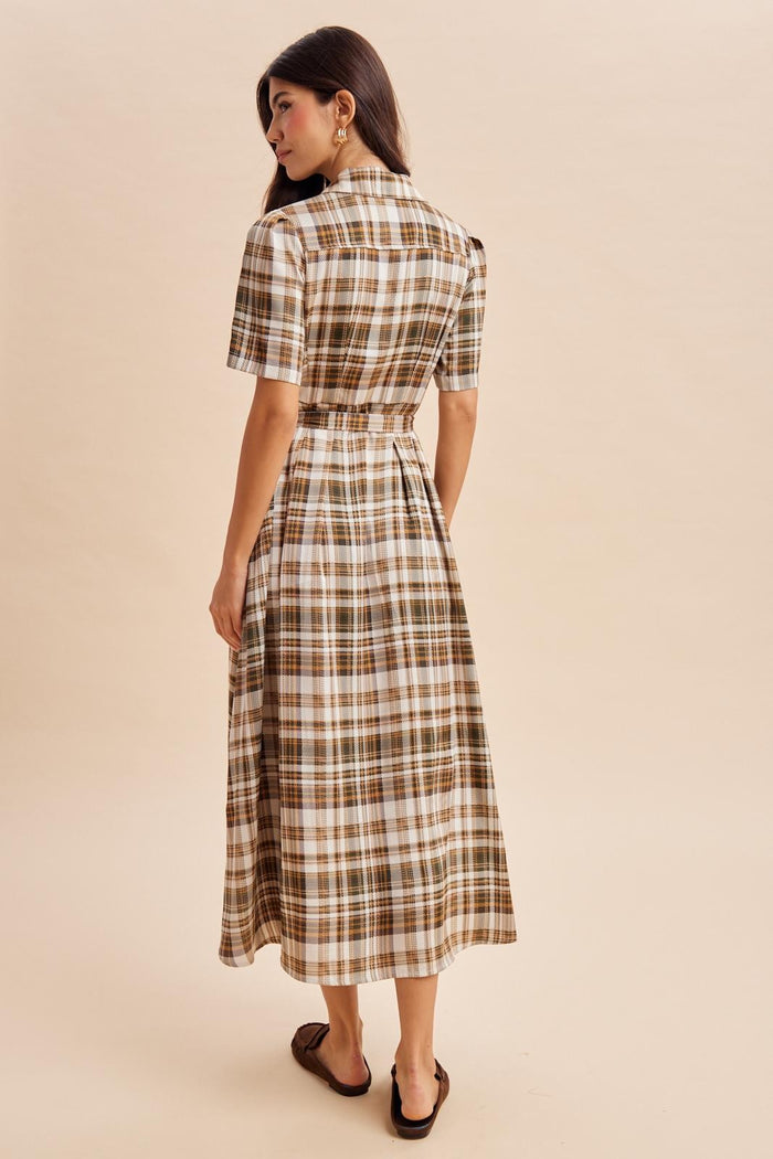 woman wearing a brown and white plaid midi dress with a belted waist and short sleeves, seen from the back