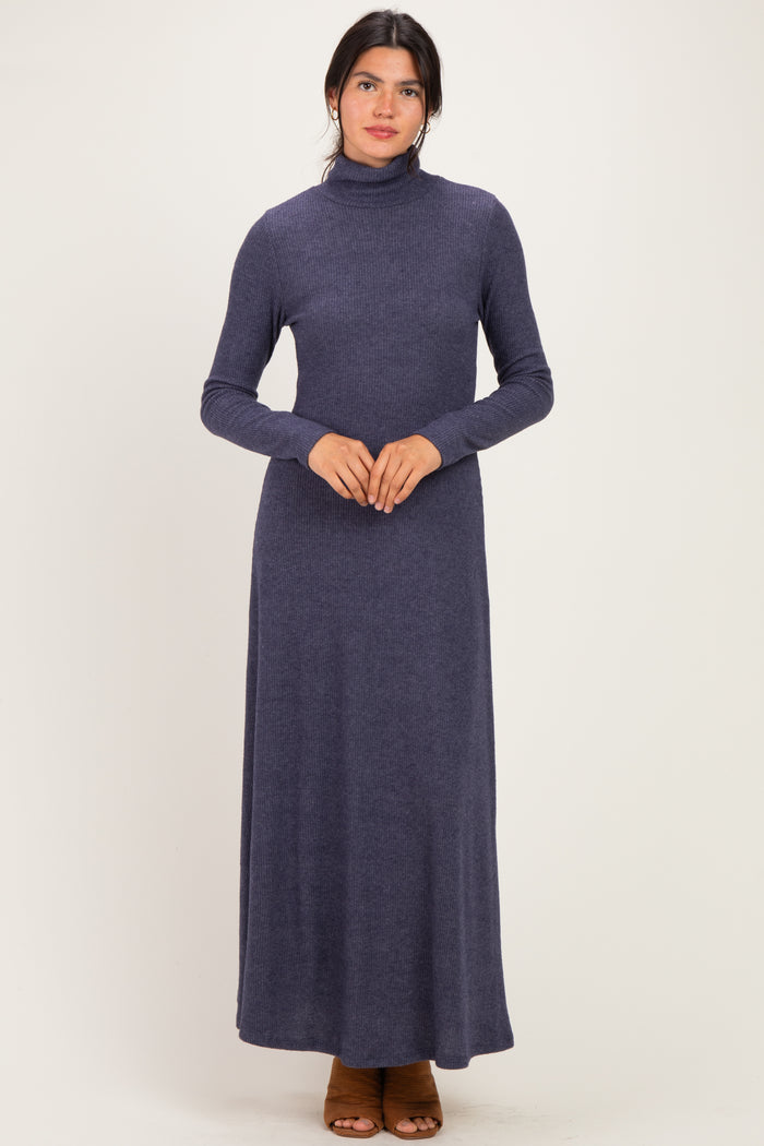 woman wearing a dark blue long sleeve turtleneck maxi dress