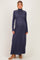 woman wearing a dark blue long sleeve ribbed maternity dress with a fitted silhouette and a visible baby bump