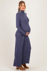 woman wearing a navy long sleeve maternity dress with turtleneck and visible baby bump