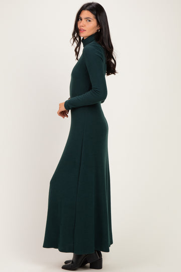 woman wearing a dark green long sleeve turtleneck maxi dress, standing sideways