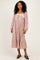 woman wearing a brown and white gingham midi dress with long sleeves and ruffle hem