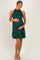 woman wearing a dark green halter neck maternity dress and holding her baby bump