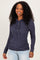 woman wearing a navy blue long sleeve hooded henley top with button details, styled with light wash jeans