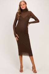 woman wearing a chocolate brown long sleeve maternity dress with a form-fitting design and turtleneck detail, showcasing her baby bump