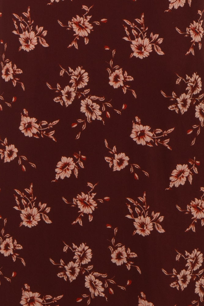 burgundy floral fabric with peach flowers and green leaves throughout
