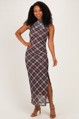 woman wearing a brown plaid maxi dress with a high neckline and side slit, smiling and posing against a neutral background