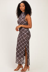 woman wearing a brown plaid sleeveless maxi dress with side slits and strappy heels