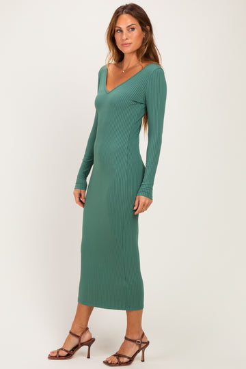 woman wearing a green ribbed long sleeve midi dress with a deep v-neck and fitted silhouette