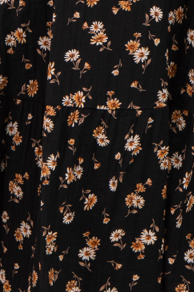 black maternity dress with white and orange floral print and pleated detailing
