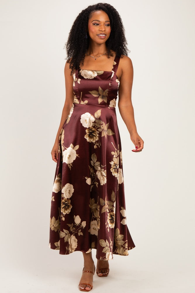 woman wearing a burgundy floral maxi dress with a square neckline and spaghetti straps