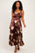 woman wearing a burgundy floral maxi dress with a square neckline and spaghetti straps