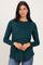 woman wearing a dark green long sleeve layered top with a relaxed fit and rounded hem