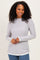 woman wearing a light gray long sleeve sweater with scalloped edges and a relaxed fit