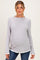 woman wearing a gray ribbed maternity top with ruffled cuffs and a visible baby bump