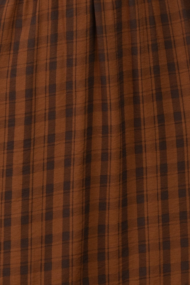 brown plaid midi skirt with a gathered waistline and soft fabric texture