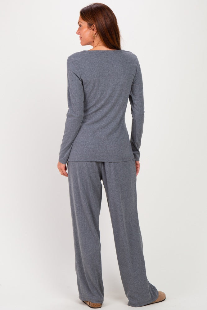 woman wearing a gray long sleeve top and matching gray wide-leg pants, viewed from the back