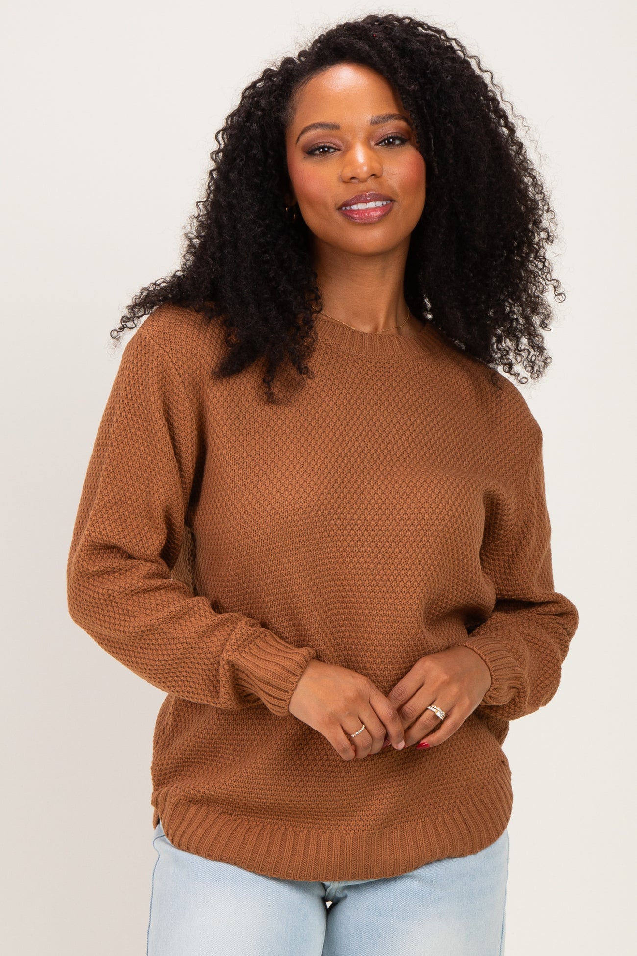 woman wearing a brown textured knit sweater with long sleeves and a relaxed fit