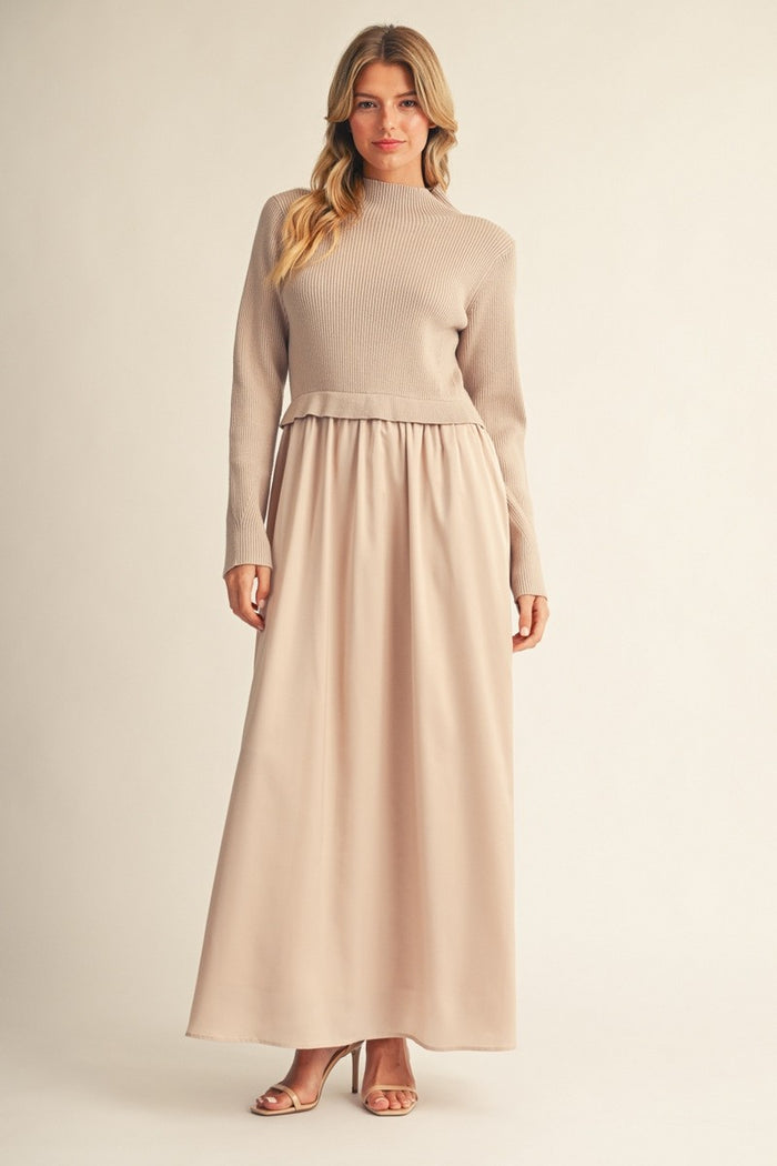 woman wearing a beige ribbed long sleeve top with a flowy beige maxi skirt and strappy heels
