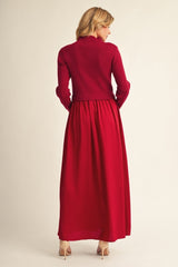 woman wearing a red long sleeve sweater and a red maxi dress, viewed from the back