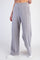 woman wearing light gray wide-leg lounge pants with an elastic waistband and front pockets